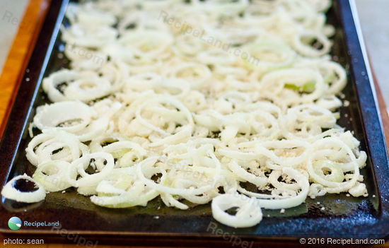 Homemade french fried onions, spread on a banking sheet, just before the oven