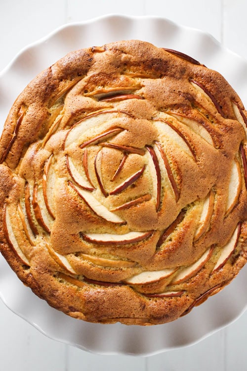 Top view of Russian sharlotka apple cake decorated with sliced apples.